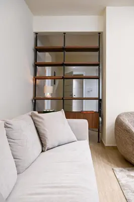 a living room with a white couch and a shelf at Sophisticated Living ,Balcony & Stunning Interior in Athens