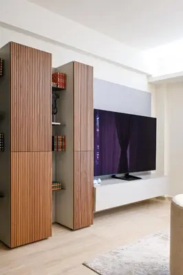a living room with a flat screen tv on a entertainment center at Sophisticated Living ,Balcony & Stunning Interior in Athens