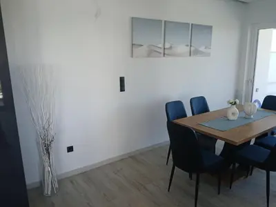 a dining room with a wooden table and blue chairs at Utopia Suit in Athens