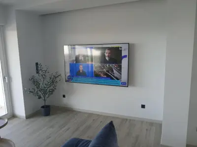 a flat screen tv hanging on a wall in a living room at Utopia Suit in Athens