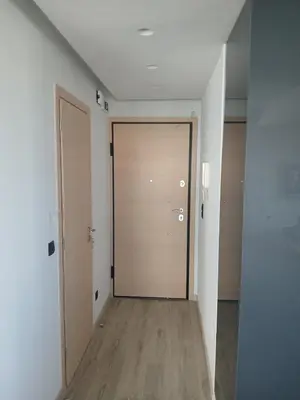 an empty hallway with a wooden door in a room at Utopia Suit in Athens