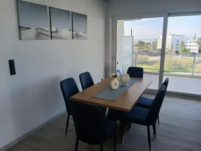 a dining room with a wooden table and blue chairs at Utopia Suit in Athens
