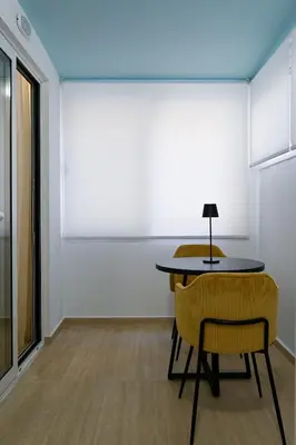 a room with a table and two chairs and a lamp at Refined Kolonaki Stay ,Private Patio & Stylish Comfort in Athens