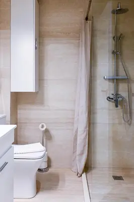 a bathroom with a shower and a toilet in it at Refined Kolonaki Stay ,Private Patio & Stylish Comfort in Athens