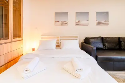 a bedroom with two beds and a leather couch at A36 Gateway to Plaka 400m 2 Syntagma Sunny patio in Athens