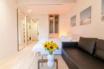 a living room with a couch and a vase of flowers at A36 Gateway to Plaka 400m 2 Syntagma Sunny patio in Athens
