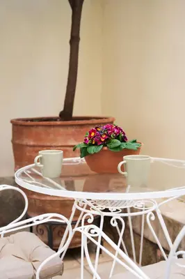 a table with two cups and a potted plant on it at A36 Gateway to Plaka 400m 2 Syntagma Sunny patio in Athens