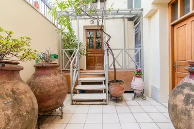 a hallway with large vases and a door at A36 Gateway to Plaka 400m 2 Syntagma Sunny patio in Athens