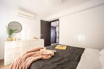 a bedroom with a large bed and a mirror at Duplex in Gazi with Acropolis view in Athens