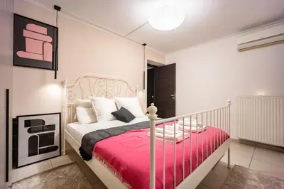 a bedroom with a bed with a red blanket at Duplex in Gazi with Acropolis view in Athens