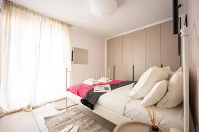 a bedroom with a bed and a large window at Duplex in Gazi with Acropolis view in Athens