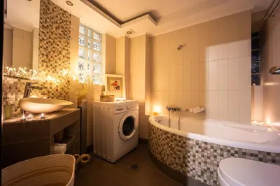 a bathroom with a tub sink and a washing machine at Duplex in Gazi with Acropolis view in Athens