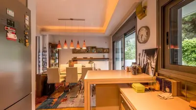 a kitchen with a table and a dining room at Superb Athens Airport Residence, Unique View in Spáta
