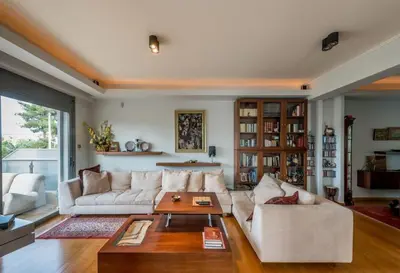 a living room with a couch and a table at Superb Athens Airport Residence, Unique View in Spáta