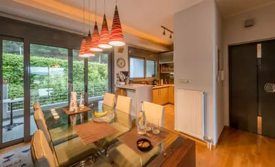 a kitchen and dining room with a table and chairs at Superb Athens Airport Residence, Unique View in Spáta