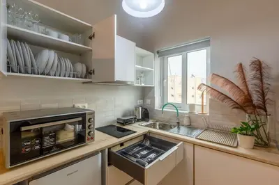 a kitchen with a microwave and a sink at Cozy Studio near the Acropolis in Athens