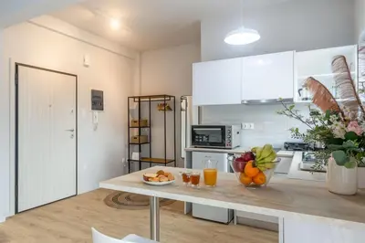 a kitchen with a table with fruit on it at Cozy Studio near the Acropolis in Athens