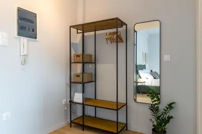 a glass shelf with a mirror in a room at Cozy Studio near the Acropolis in Athens