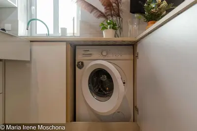 a washing machine in a kitchen with a counter at Cozy Studio near the Acropolis in Athens