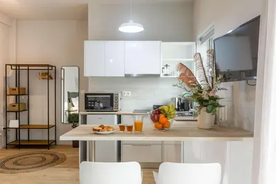 a kitchen with a table with fruits and drinks on it at Cozy Studio near the Acropolis in Athens