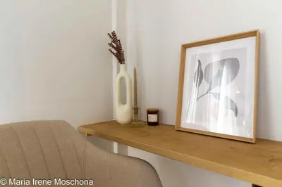 a table with a picture and a vase on it at Cozy Studio near the Acropolis in Athens