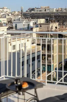 a view of a building from a balcony at Rooftops of Athens - Vathi Studio Jacuzzi & View in Athens