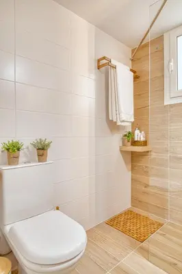 a bathroom with a toilet and a shower at Elegant family apartment with marvelous garden in Athens