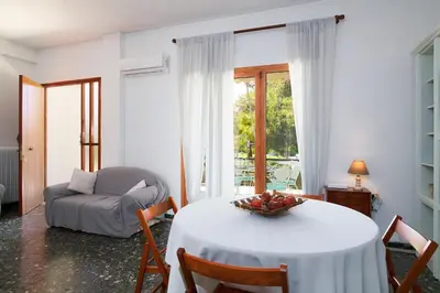 a living room with a table with a bowl of fruit on it at Elegant family apartment with marvelous garden in Athens