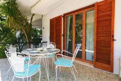 a table and chairs sitting on a patio at Elegant family apartment with marvelous garden in Athens