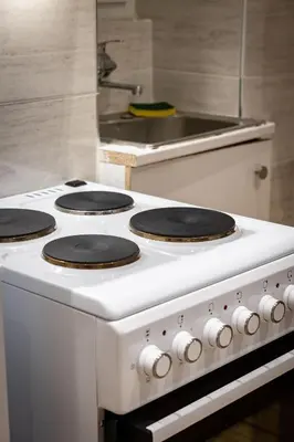 a white stove top oven in a kitchen at Nova Domo in Athens