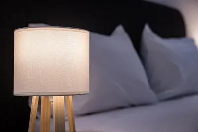 a lamp sitting on top of a bed with pillows at Nova Domo in Athens