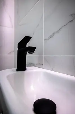 a bath tub with a faucet in a bathroom at Nova Domo in Athens