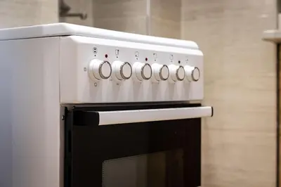 a white stove top oven in a kitchen at Nova Domo in Athens