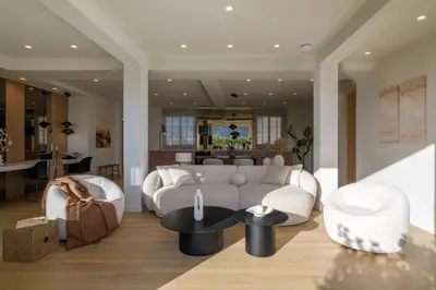 a living room with a couch and a table at Acropolis Penthouse Plunge Pool in Athens