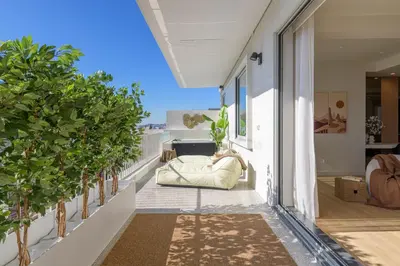a balcony with a couch and trees on a building at Acropolis Penthouse Plunge Pool in Athens
