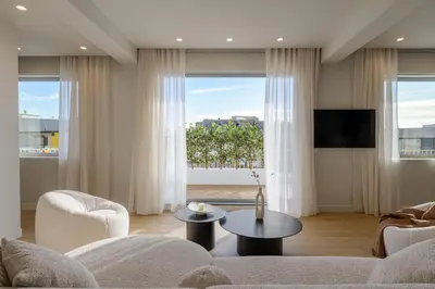 a living room with a couch and a tv at Acropolis Penthouse Plunge Pool in Athens