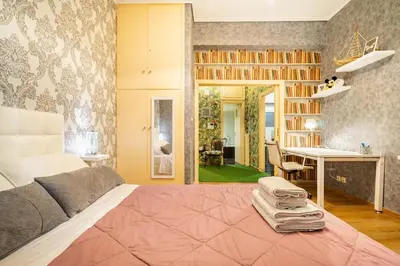 a bedroom with a bed and a desk and a table at Easily accessible secure Ground floor with breakfast items in Athens