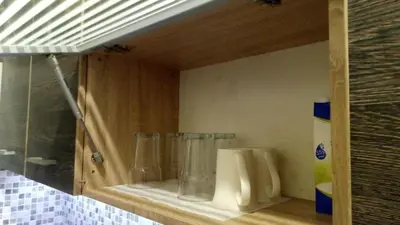 a cabinet with three glass vases sitting on a shelf at Easily accessible secure Ground floor with breakfast items in Athens