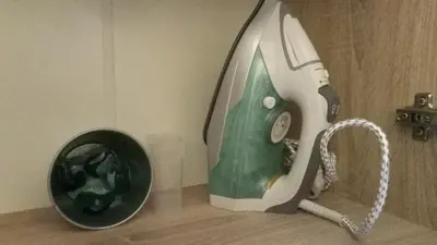 a iron is sitting next to a trash can at Easily accessible secure Ground floor with breakfast items in Athens
