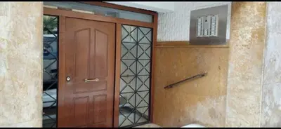 a wooden door in a building with a window at Easily accessible secure Ground floor with breakfast items in Athens