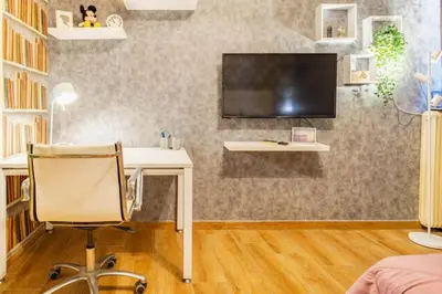 a room with a desk and a tv on a wall at Easily accessible secure Ground floor with breakfast items in Athens