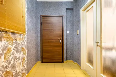 a hallway with a wooden door in a room at Sophisticated Penthouse and breakfast items in Athens