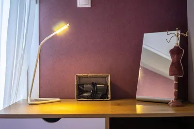 a lamp sitting on a table next to a mirror at Sophisticated Penthouse and breakfast items in Athens