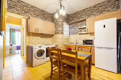a kitchen with a table and a washer and dryer at Sophisticated Penthouse and breakfast items in Athens
