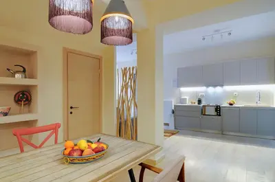 a kitchen with a table with a bowl of fruit on it at Arditos Hill Residence in Athens