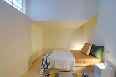 a bedroom with a bed in a room with a window at Arditos Hill Residence in Athens