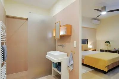 a bathroom with a bed and a sink in a room at Arditos Hill Residence in Athens
