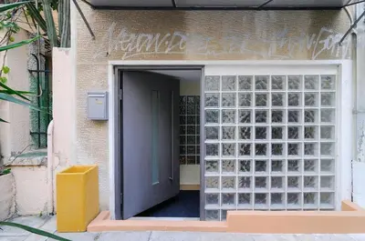 a door into a building with glass panels at Arditos Hill Residence in Athens