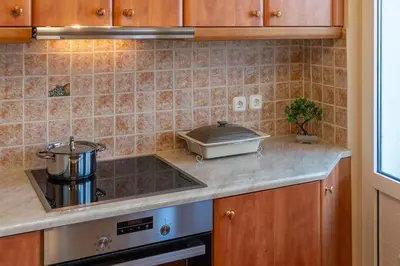 a kitchen with a stove and a counter top at Cozy Athens Stay near Metro Mall Casa Antigone in Athens