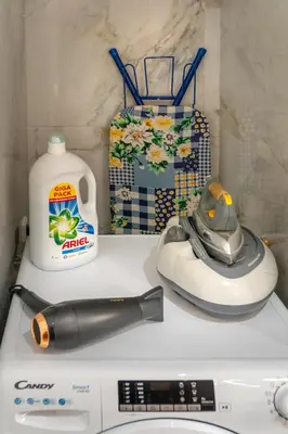 a counter top with a hair dryer and a bottle of milk at Cozy Athens Stay near Metro Mall Casa Antigone in Athens
